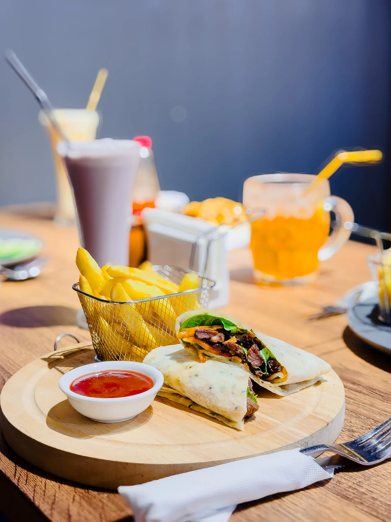Sliced wrap served with fries and dipping sauce