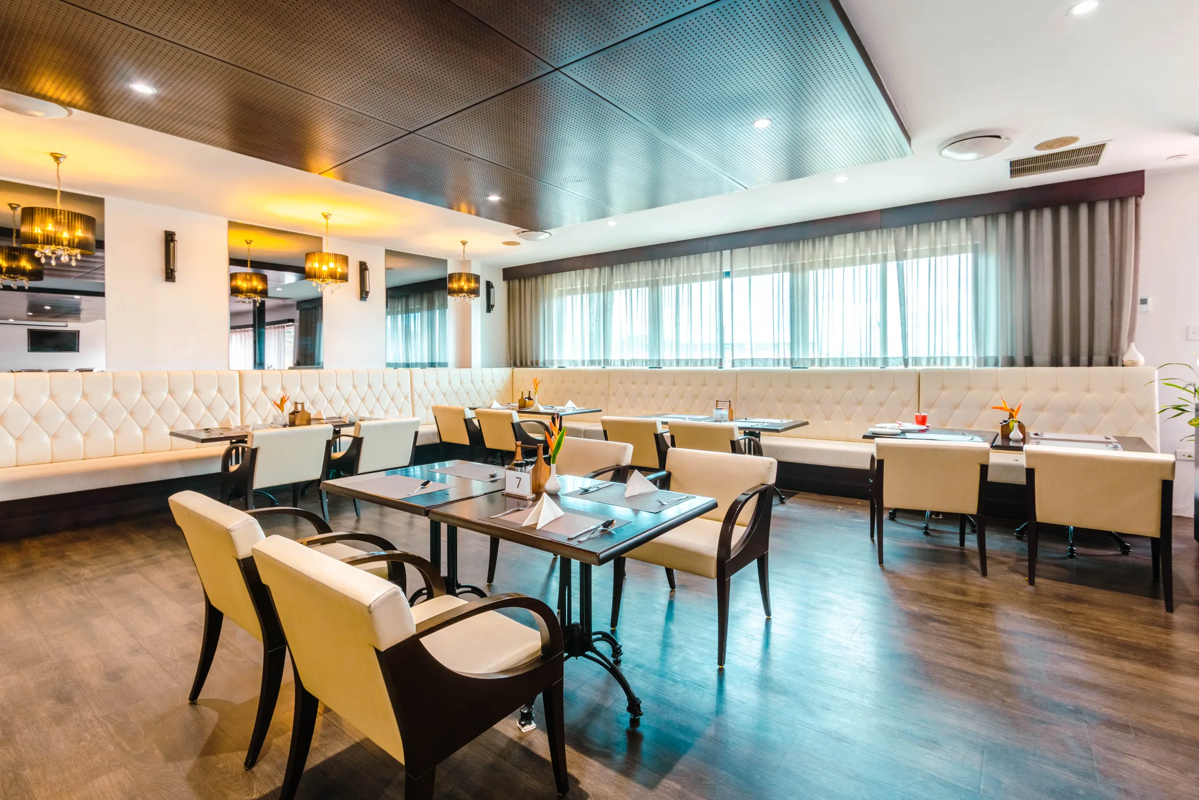 Set dining tables and cream seating in a restaurant