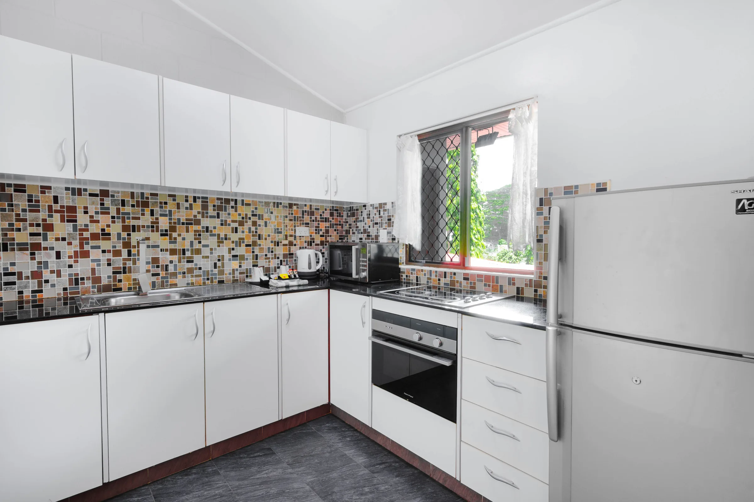 White kitchen with a mosaic tile splashback
