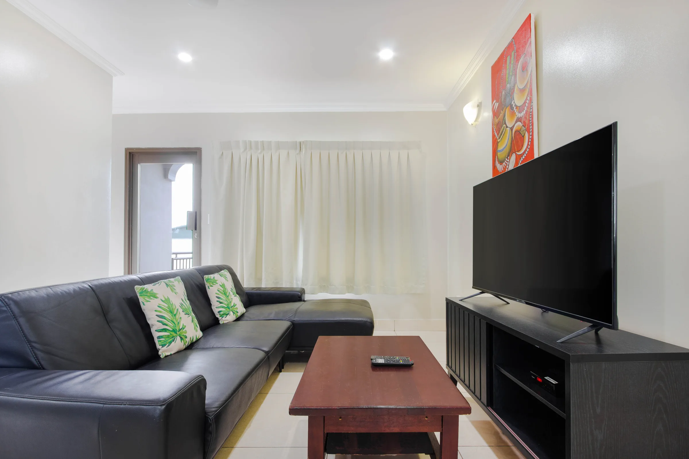 Living room with a dark sofa and television