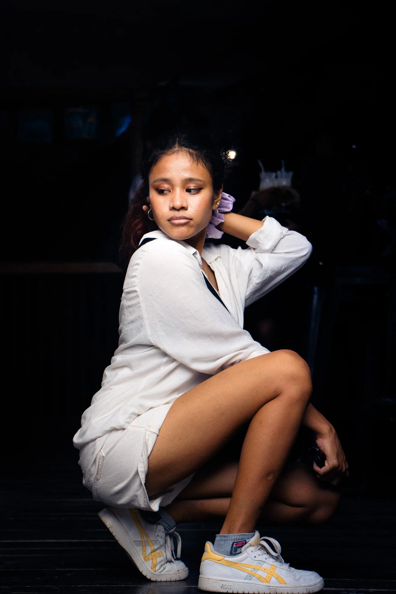 Portrait of a seated woman against a dark background