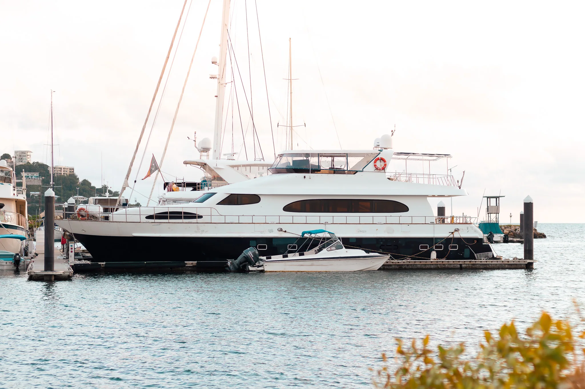Side view of a yacht with a smaller boat alongside